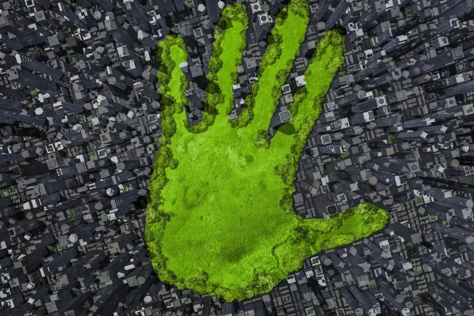 Green handprint over a city skyline representing Tamturbo's carbon footprint reduction and decarbonize compressed air mission